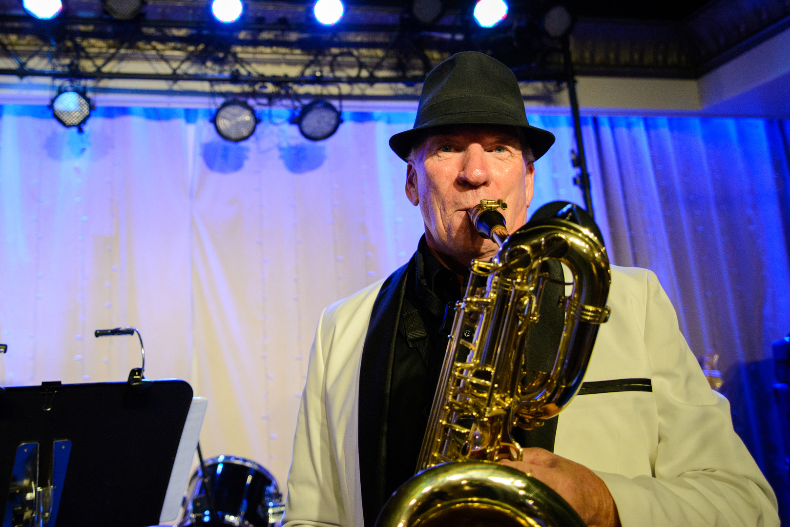 A man playing a bass saxophone